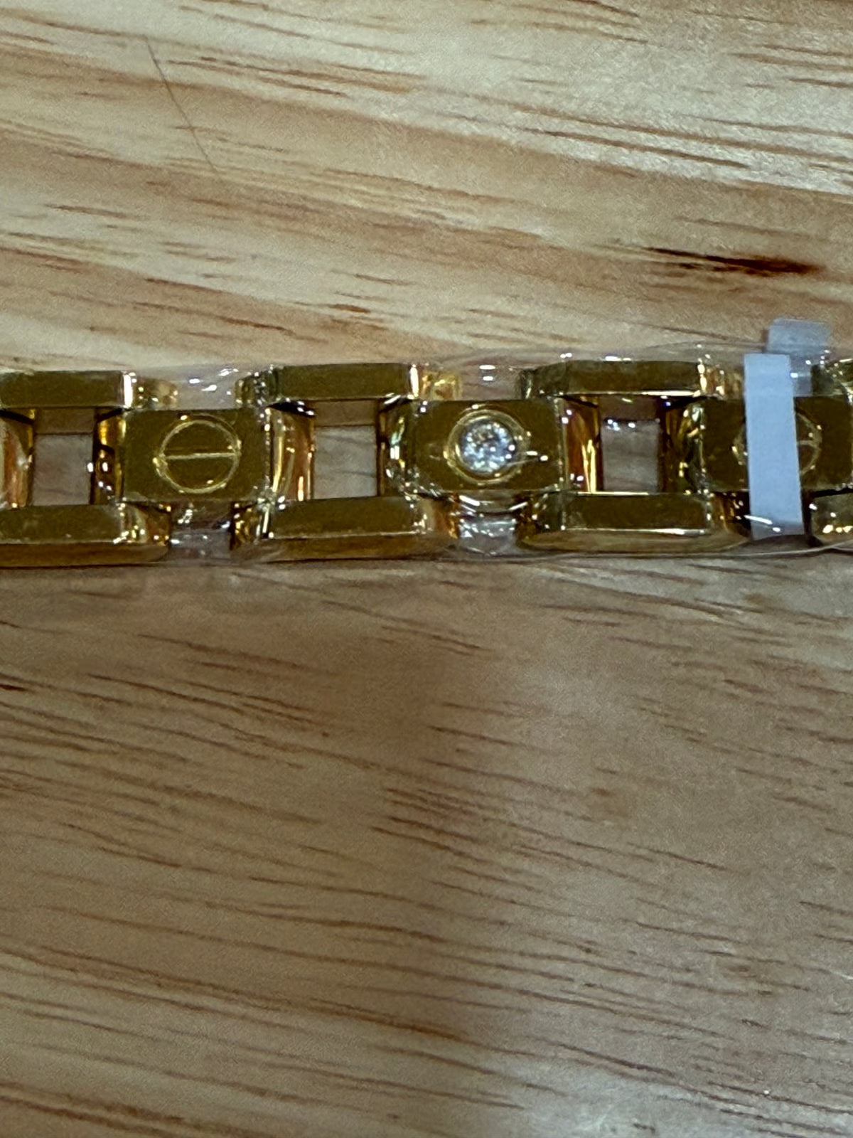 Signature Screw Motif Link Bracelet Elegant Gold Tone with Stone Detailin