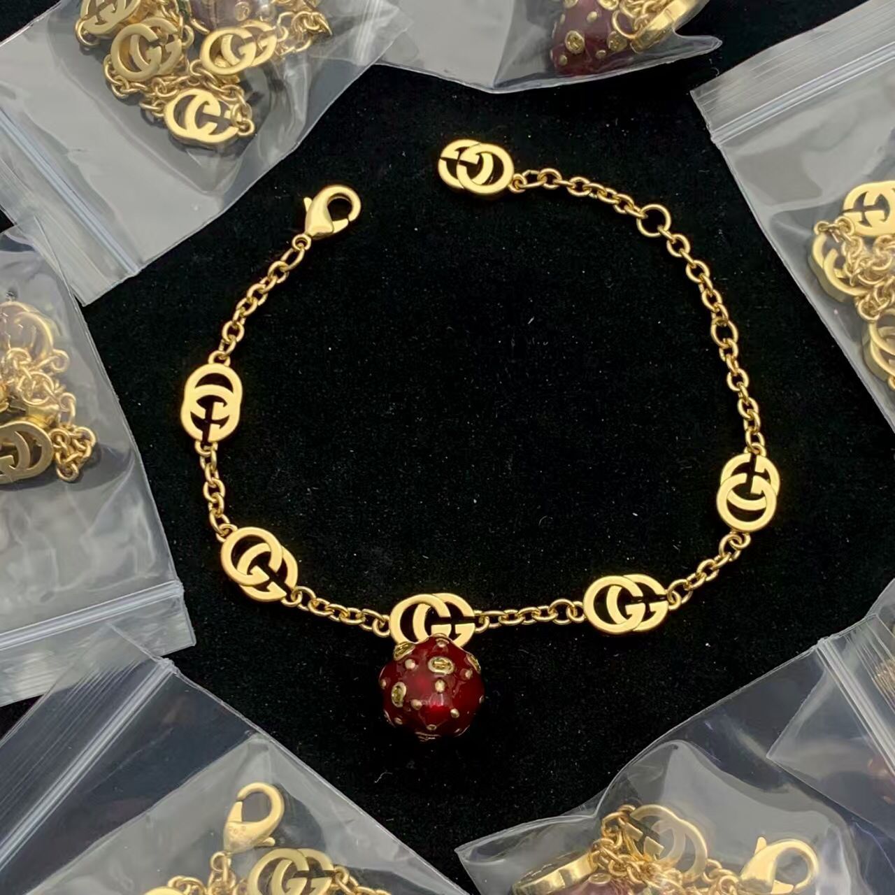 Charming Gold Tone Link Bracelet with Ruby Red Enamel Sphere